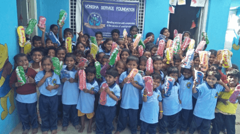 Students showing donated supplies