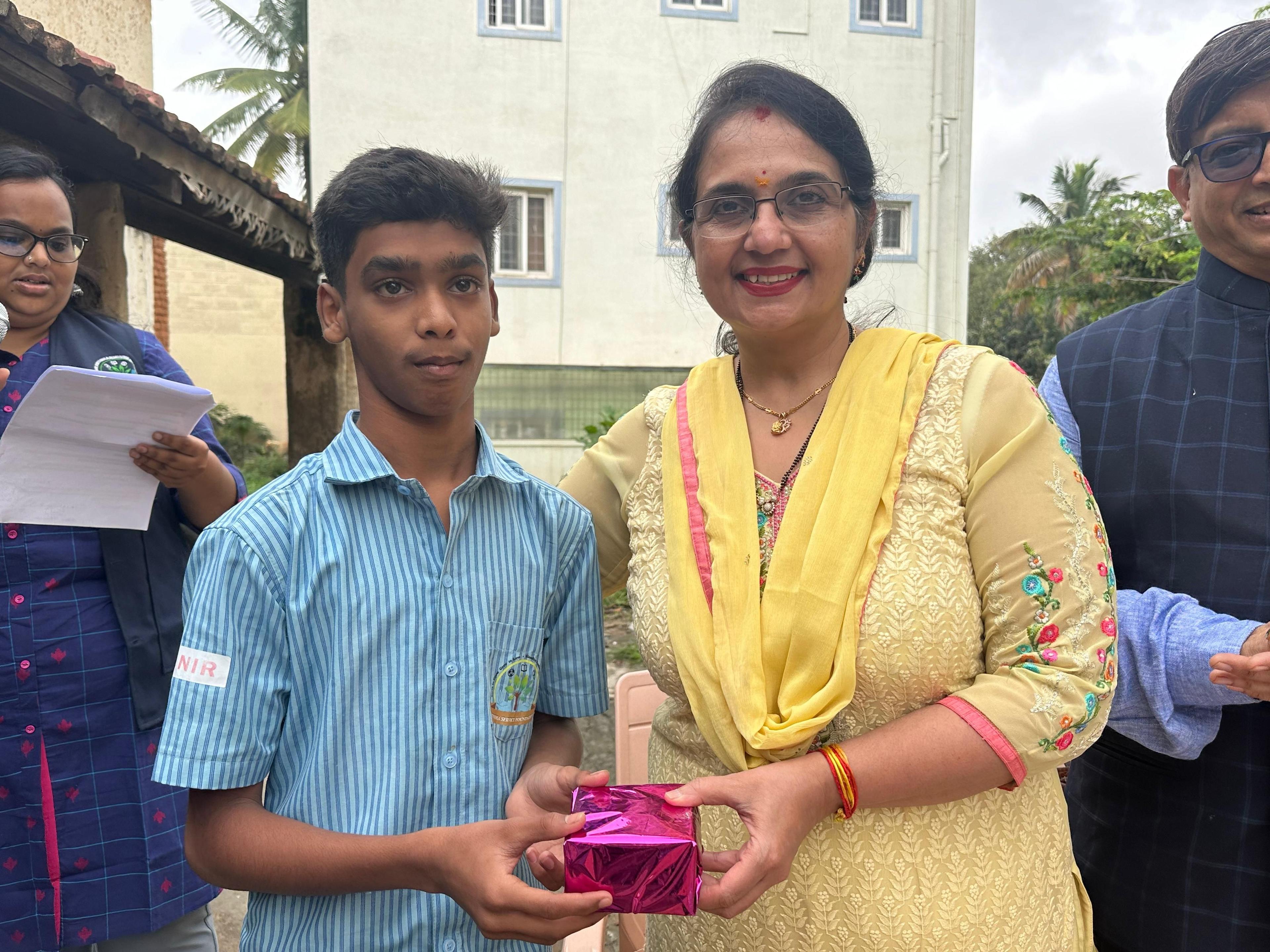 Student in SchoolFinish program receiving a gift